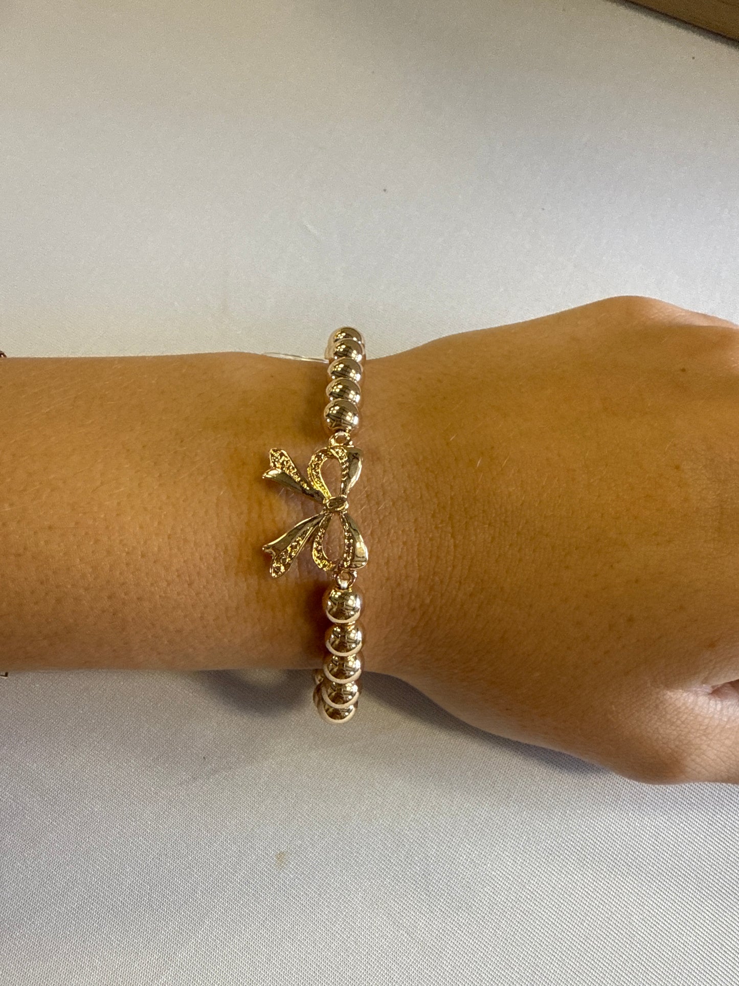 Gold Beaded Bracelet with Gold Metal Bow